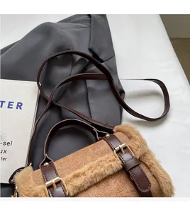 Detail of plush faux fur shoulder bag with leather straps and metal hardware