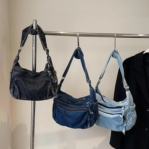 Three multi-pocket denim shoulder bags in black, dark blue and light blue colors