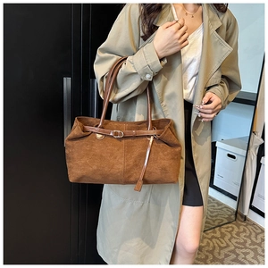 Brown matte tote bag styled with a beige trench coat for a vintage commuting look