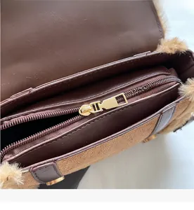Detailed macro view of the smooth gold metal zipper and inner compartment of the bag