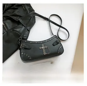 Detail view of gothic black PU crossbody bag with silver cross pendant and metal studs