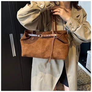 Detail of vintage brown frosted tote bag showing soft suede texture and leather strap