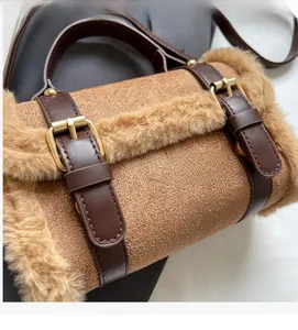 Close-up of caramel plush fabric and dark brown leather strap on a small crossbody bag