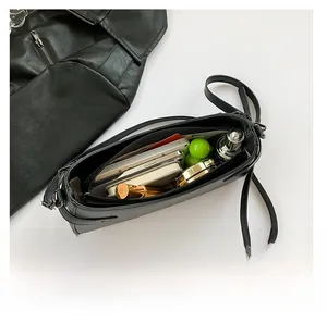 Interior storage capacity of the black PU leather shoulder bag for daily essentials