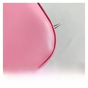 Macro view of pink lychee pattern leather with silver sharp metal stud details