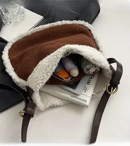 Interior view of brown suede shoulder bag with plush trim showing spacious storage capacity