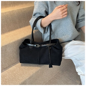 Detail of vintage black matte tote bag showing suede texture and contrast leather handles