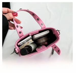 Interior view of pink gothic studded handbag showing space for phone and cosmetics