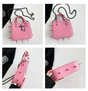 Detail view of pink gothic crossbody bag with silver studs and cross pendant decoration