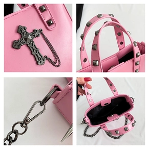 Detail of pink gothic handbag showing silver cross charms and metal rivet studs
