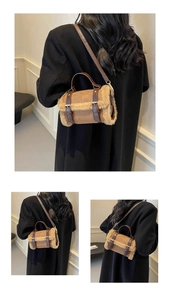 Detail view of a mini plush cylinder shoulder bag with faux shearling and brown suede finish