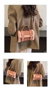 Detailed view of pink plush crossbody bag with faux suede and metal buckle straps