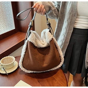 Close-up of the plush white faux fur trim and brown suede material on the shoulder bag