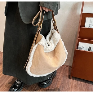 Detail of winter crossbody tote showing lamb wool trim and suede texture with metal ring