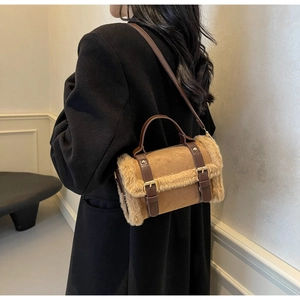 Close-up of the vintage brown faux fur trim and gold buckle straps on the autumn handbag