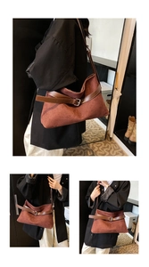 Detail of red-brown faux suede tote bag with a dark brown leather strap and silver buckle