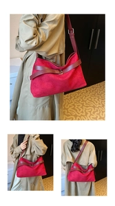 Close-up of rose red matte suede shoulder bag with burgundy leather straps and metal buckle