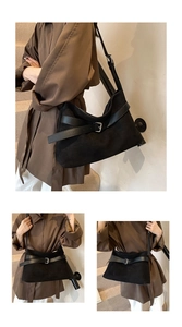 Detail of black faux suede tote bag featuring silver buckle strap and large capacity