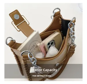 Internal view showing storage space for phone and notebook in brown leather bag