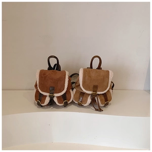 Close-up of suede backpacks with faux shearling trim in coffee and beige colors