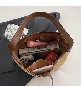 Spacious interior of brown and beige tote bag holding books, phone, and daily essentials
