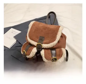Macro shot of brown suede texture and cream faux fur trim on a vintage backpack detail