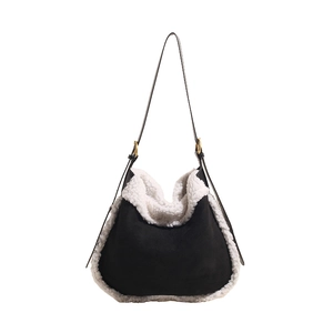 Chic black suede hobo bag with white faux shearling trim and slim leather shoulder strap