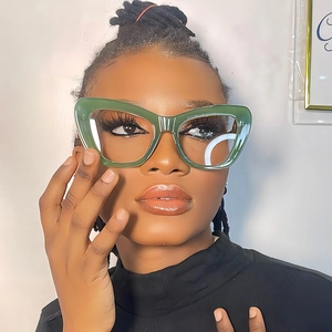 Elegant green cat-eye sunglasses for women with thick frames and retro fashion design