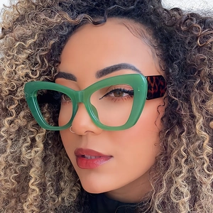 Fashionable cat-eye sunglasses with green transparent frames and leopard print temples