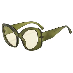 Elegant cat eye sunglasses with frosted green frames and translucent yellow lenses