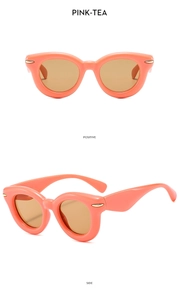 Detail view of pink-tea cat eye sunglasses with gold rivets from positive and side angles