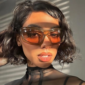 Fashionable amber square wrap-around sunglasses with orange gradient lenses on model