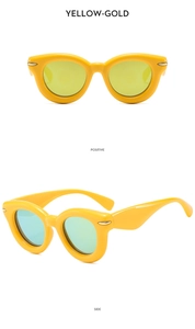 Detail view of yellow thick frame sunglasses with metal dots and gold reflective lenses