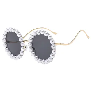 Luxury round sunglasses for women featuring pearl decorations and golden wavy metal arms