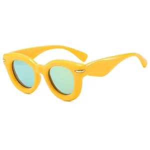 Fashionable thick yellow frame sunglasses with light green lenses for a vintage retro look