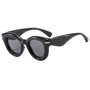 Fashionable black thick frame cat eye sunglasses with gold rivet accents on white background