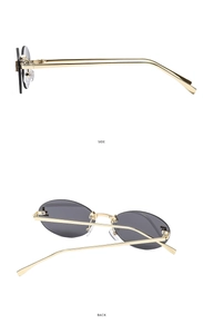 Detail view of oval rimless sunglasses featuring golden metal temples and dark grey lenses
