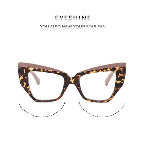 Detail of cat-eye eyewear showing tortoise shell texture and soft pink top bar design