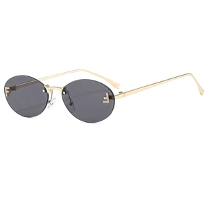Vintage rimless oval sunglasses with grey lenses and gold metal frames with F rhinestones
