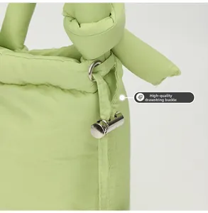 Detail of premium drawstring metal buckle and quilted fabric on mint green shoulder bag