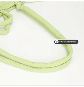Detail of soft quilted nylon shoulder strap in light green for versatile handbags