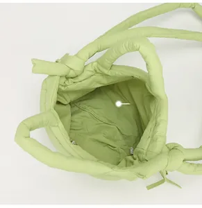 Top view of puffy green nylon bag showing spacious interior and magnetic closure