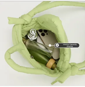 Top view of the spacious inner compartment of the light green padded nylon tote bag