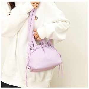 Close-up of light purple padded nylon drawstring bag with soft puffy cloud texture