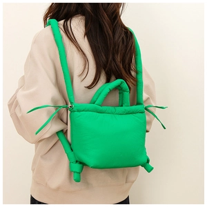 Detail of bright green nylon padded backpack with soft drawstring sides and thick straps
