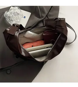 Macro view showing large capacity interior of dark brown PU leather shoulder bag