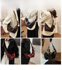 Detailed view of large crescent shoulder bags in multiple colors with glossy finish