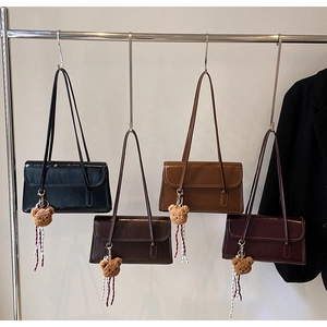 Selection of retro shoulder bags in black, coffee, brown, and wine red with bear charms