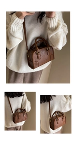 Detail view of brown vintage Boston pillow bag featuring retro gold metal hardware and texture