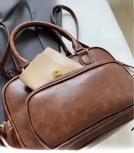 Detail view of brown vintage PU leather handbag showing internal storage for a wallet